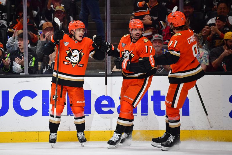 Nov 28, 2025; Anaheim, California, USA; Anaheim Ducks defenseman Olen Zellweger (51) celebrates his goal scored against the Los Angeles Kings with left wing Alex Killorn (17) and center Leo Carlsson (91) during the second period at Honda Center. Mandatory Credit: Gary A. Vasquez-Imagn Images