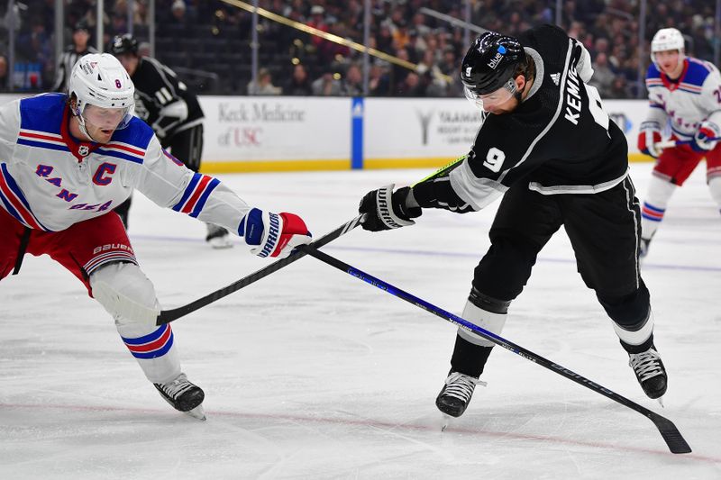 Jan 20, 2024; Los Angeles, California, USA; Los Angeles Kings right wing Adrian Kempe (9) shoots against New York Rangers defenseman Jacob Trouba (8) durng the second period at Crypto.com Arena. Mandatory Credit: Gary A. Vasquez-USA TODAY Sports