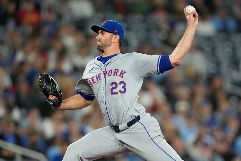 Sep 10, 2024; Toronto, Ontario, CAN; New York Mets starting pitcher David Peterson (23) pitches to the Toronto Blue Jays during the third inning at Rogers Centre. Mandatory Credit: John E. Sokolowski-Imagn Images