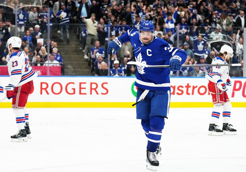 Oct 19, 2024; Toronto, Ontario, CAN; Toronto Maple Leafs center Auston Matthews (34) celebrates after scoring a goal New York Rangers during the third period at Scotiabank Arena. Mandatory Credit: Nick Turchiaro-Imagn Images