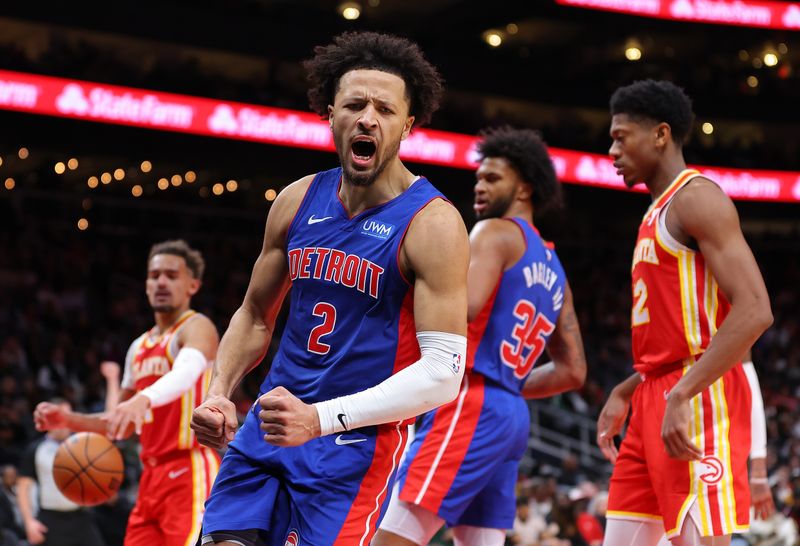 ATLANTA, GEORGIA - DECEMBER 18:  Cade Cunningham #2 of the Detroit Pistons reacts as he draws a foul after dunking against Trae Young #11 of the Atlanta Hawks during the fourth quarter at State Farm Arena on December 18, 2023 in Atlanta, Georgia.  NOTE TO USER: User expressly acknowledges and agrees that, by downloading and/or using this photograph, user is consenting to the terms and conditions of the Getty Images License Agreement.  (Photo by Kevin C. Cox/Getty Images)