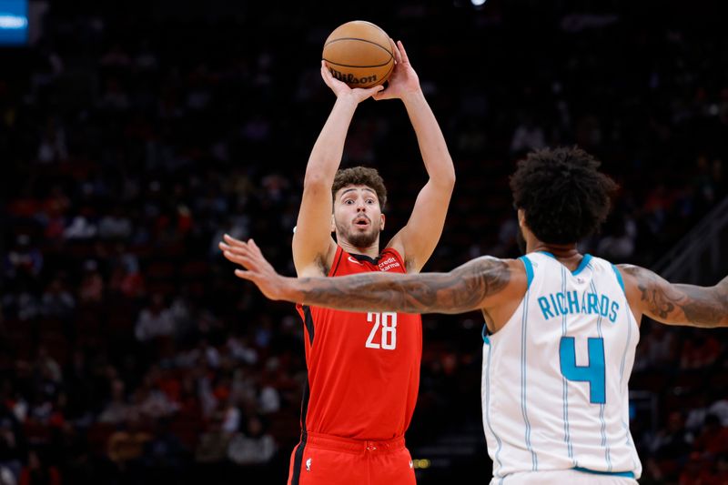 HOUSTON, TEXAS - NOVEMBER 01: Alperen Sengun #28 of the Houston Rockets puts up a shot over Nick Richards #4 of the Charlotte Hornets during the first half at Toyota Center on November 01, 2023 in Houston, Texas. (Photo by Carmen Mandato/Getty Images)