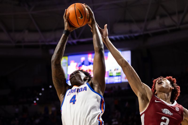 Jan 13, 2024; Gainesville, Florida, USA; Florida Gators forward Tyrese Samuel (4) rebounds the ball over Arkansas Razorbacks forward Trevon Brazile (2) during the first half at Exactech Arena at the Stephen C. O'Connell Center. Mandatory Credit: Matt Pendleton-USA TODAY Sports