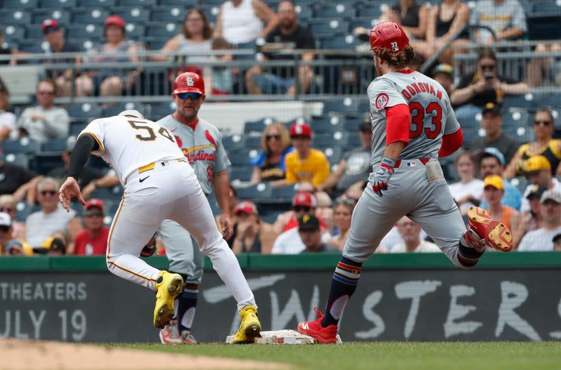 Jul 4, 2024; Pittsburgh, Pennsylvania, USA; St. Louis Cardinals left fielder Brendan Donovan (33) beats a throw to Pittsburgh Pirates starting pitcher Martín Pérez (54) to reach base during the second inning at PNC Park. Mandatory Credit: Charles LeClaire-USA TODAY Sports