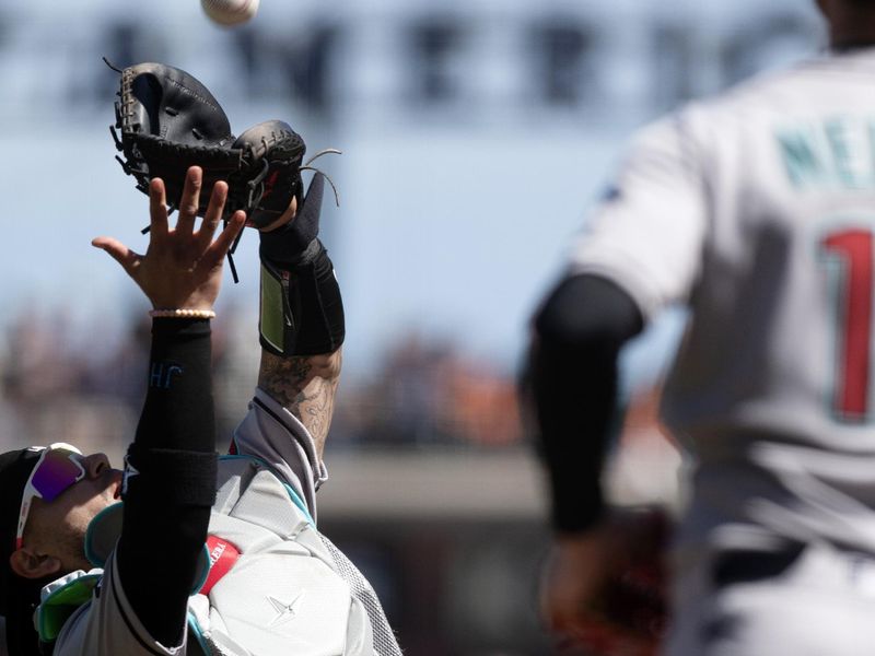 May 14, 2025; San Francisco, California, USA; Arizona Diamondbacks catcher Jose Herrera (11) makes the catch of a popup off the bat of San Francisco Giants designated hitter Wilmer Flores during the eighth inning at Oracle Park. Mandatory Credit: D. Ross Cameron-Imagn Images