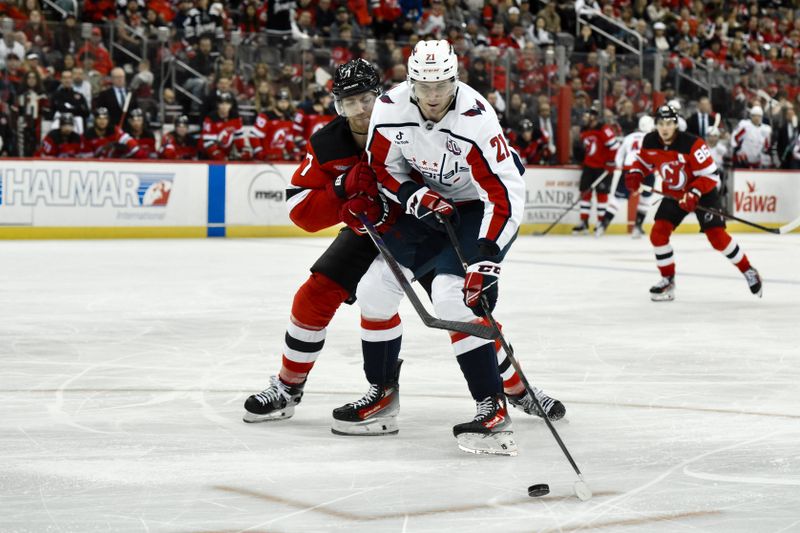 Oct 19, 2024; Newark, New Jersey, USA; Washington Capitals center Aliaksei Protas (21) skates with the puck against New Jersey Devils defenseman Dougie Hamilton (7) during the third period at Prudential Center. Mandatory Credit: John Jones-Imagn Images