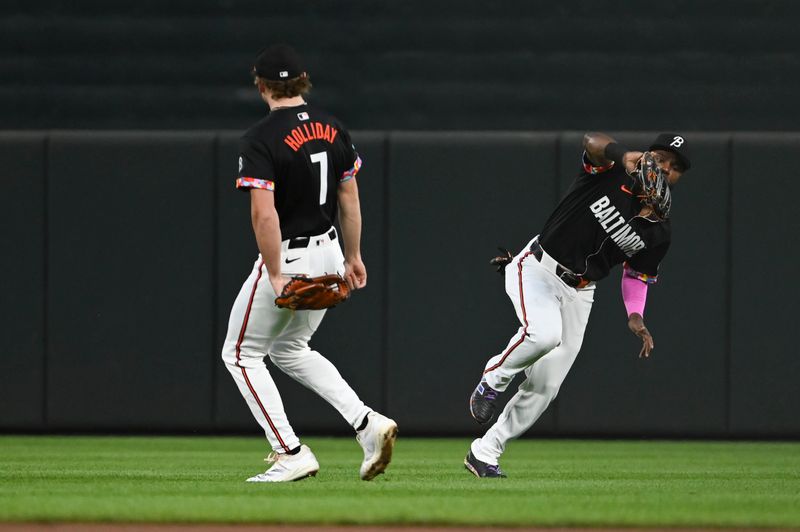 Sep 6, 2024; Baltimore, Maryland, USA;  Baltimore Orioles outfielder Cedric Mullins (31) catches a ]second inning fly ball as  second base Jackson Holliday (7) looks on against the Tampa Bay Rays at Oriole Park at Camden Yards. Mandatory Credit: Tommy Gilligan-Imagn Images