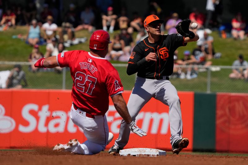 Mar 20, 2024; Tempe, Arizona, USA; San Francisco Giants shortstop Nick Ahmed (40) gets the out on Los Angeles Angels center fielder Mike Trout (27) in the first inning at Tempe Diablo Stadium. Mandatory Credit: Rick Scuteri-USA TODAY Sports