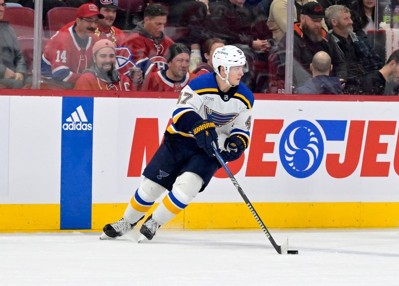 Feb 11, 2024; Montreal, Quebec, CAN; St.Louis Blues defenseman Torey Krug (47) plays the puck during the second period of the game against the Montreal Canadiens at the Bell Centre. Mandatory Credit: Eric Bolte-USA TODAY Sports