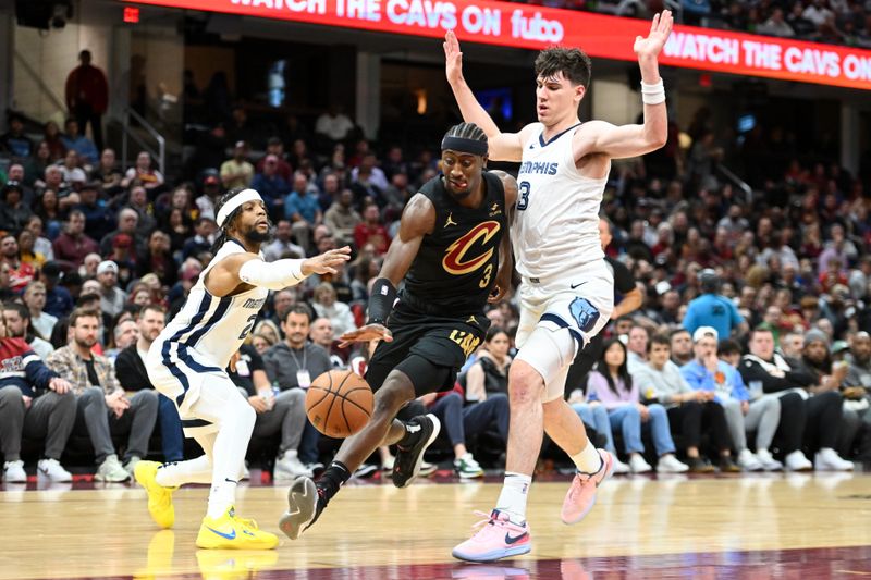 CLEVELAND, OHIO - APRIL 10: Caris LeVert #3 of the Cleveland Cavaliers drives to the basket against Zavier Simpson #2 and Jake LaRavia #3 of the Memphis Grizzlies during the first half at Rocket Mortgage Fieldhouse on April 10, 2024 in Cleveland, Ohio. NOTE TO USER: User expressly acknowledges and agrees that, by downloading and or using this photograph, User is consenting to the terms and conditions of the Getty Images License Agreement. (Photo by Nick Cammett/Getty Images)