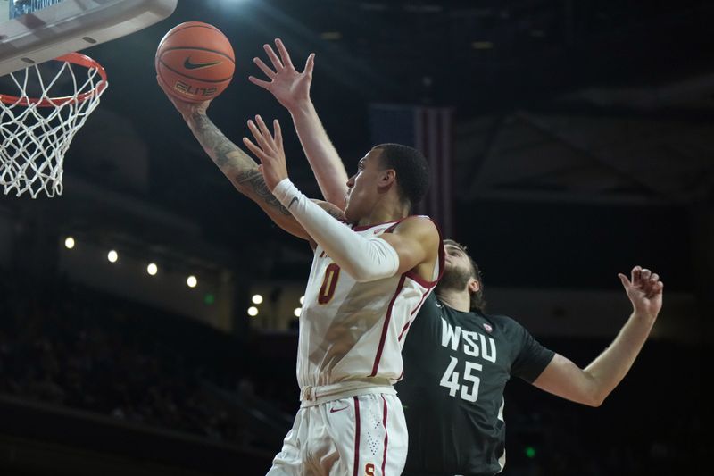 Jan 10, 2024; Los Angeles, California, USA; Southern California Trojans guard Kobe Johnson (0) shoots the ball in the second half against Washington State Cougars forward Oscar Cluff (45) at Galen Center. Mandatory Credit: Kirby Lee-USA TODAY Sports