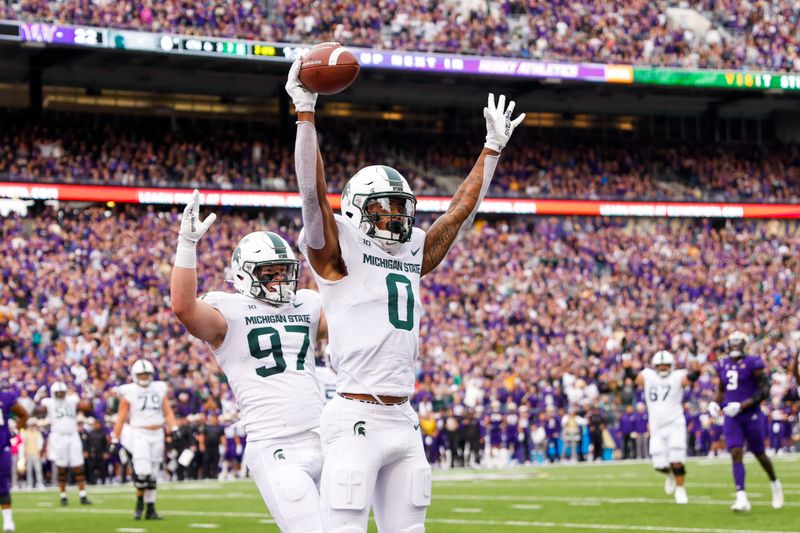 Sep 17, 2022; Seattle, Washington, USA; Michigan State Spartans wide receiver Keon Coleman (0) celebrates with tight end Tyler Hunt (97) after catching a touchdown pass during the second quarter at Alaska Airlines Field at Husky Stadium. Mandatory Credit: Joe Nicholson-USA TODAY Sports