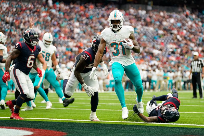 Miami Dolphins running back Raheem Mostert (31) scores a touchdown against the Houston Texans during the first half of an NFL preseason football game, Saturday, Aug. 19, 2023, in Houston. (AP Photo/Eric Christian Smith)