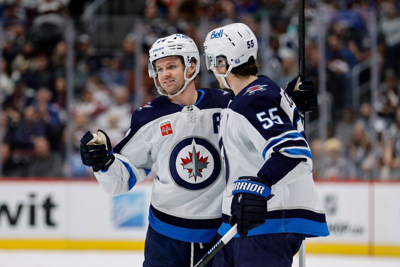 Apr 13, 2024; Denver, Colorado, USA; Winnipeg Jets defenseman Josh Morrissey (44) celebrates his goal with center Mark Scheifele (55) in the first period against the Colorado Avalanche at Ball Arena. Mandatory Credit: Isaiah J. Downing-USA TODAY Sports