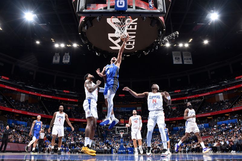 ORLANDO, FL - MARCH 29: Jalen Suggs #4 of the Orlando Magic drives to the basket during the game against the LA Clippers on March 29, 2024 at the Kia Center in Orlando, Florida. NOTE TO USER: User expressly acknowledges and agrees that, by downloading and or using this photograph, User is consenting to the terms and conditions of the Getty Images License Agreement. Mandatory Copyright Notice: Copyright 2024 NBAE (Photo by Fernando Medina/NBAE via Getty Images)