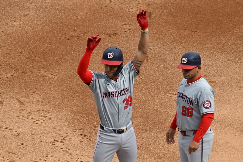 May 14, 2024; Chicago, Illinois, USA;  Washington Nationals third base Trey Lipscomb (38) signals with  first base coach Gerardo Parra (88) after he singled against the Chicago White Sox during the second inning at Guaranteed Rate Field. Mandatory Credit: Matt Marton-USA TODAY Sports