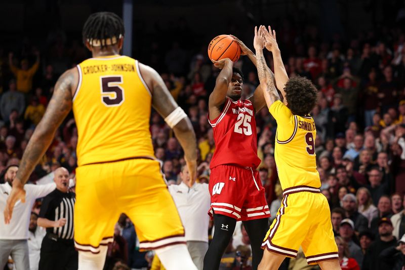 Jan 13, 2026; Minneapolis, Minnesota, USA; Wisconsin Badgers guard John Blackwell (25) shoots the game winning shot as Minnesota Golden Gophers guard Kai Shinholster (9) defends during the second half at Williams Arena. Mandatory Credit: Matt Krohn-Imagn Images