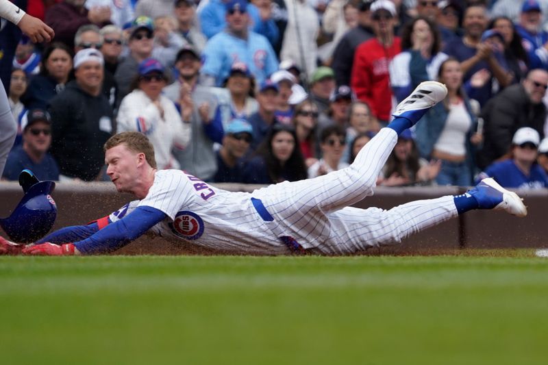 May 18, 2025; Chicago, Illinois, USA; Chicago Cubs outfielder Pete Crow-Armstrong (4) dives into third base with a triple against the Chicago White Sox during the first inning at Wrigley Field. Mandatory Credit: David Banks-Imagn Images