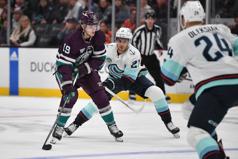 Dec 23, 2023; Anaheim, California, USA; Anaheim Ducks right wing Troy Terry (19) moves the puck ahead of Seattle Kraken center Alex Wennberg (21) during the second period at Honda Center. Mandatory Credit: Gary A. Vasquez-USA TODAY Sports