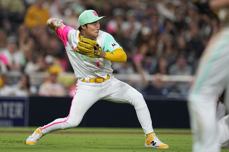 Aug 18, 2023; San Diego, California, USA; San Diego Padres third baseman Ha-Seong Kim (7) throws out Arizona Diamondbacks shortstop Geraldo Perdomo (2) at second base during the seventh inning at Petco Park. Mandatory Credit: Ray Acevedo-USA TODAY Sports