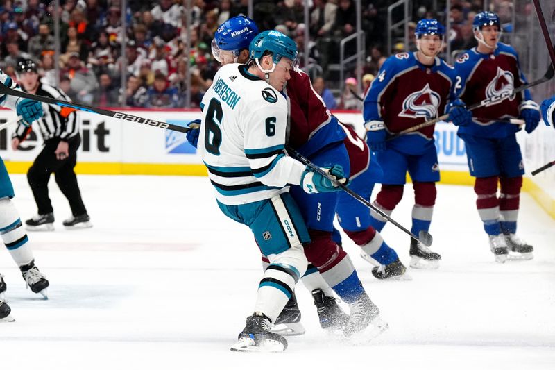 Dec 31, 2023; Denver, Colorado, USA; Colorado Avalanche center Nathan MacKinnon (29) hits San Jose Sharks defenseman Ty Emberson (6) in the second period at Ball Arena. Mandatory Credit: Ron Chenoy-USA TODAY Sports