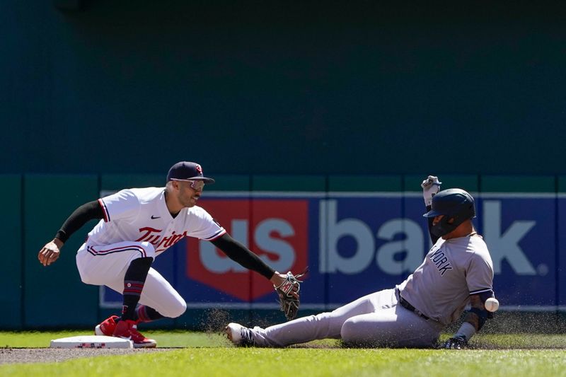 Apr 26, 2023; Minneapolis, Minnesota, USA; Minnesota Twins infielder Carlos Correa (4) mishandles a throw that allows New York Yankees infielder Gleyber Torres (25) to reach second on a double during the second inning at Target Field. Mandatory Credit: Nick Wosika-USA TODAY Sports

