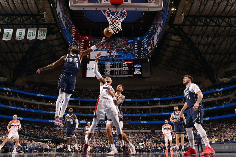 DALLAS, TX - FEBRUARY 12: Kyrie Irving #11 of the Dallas Mavericks reaches for the ball during the game against the Washington Wizards on February 12, 2024 at the American Airlines Center in Dallas, Texas. NOTE TO USER: User expressly acknowledges and agrees that, by downloading and or using this photograph, User is consenting to the terms and conditions of the Getty Images License Agreement. Mandatory Copyright Notice: Copyright 2024 NBAE (Photo by Glenn James/NBAE via Getty Images)