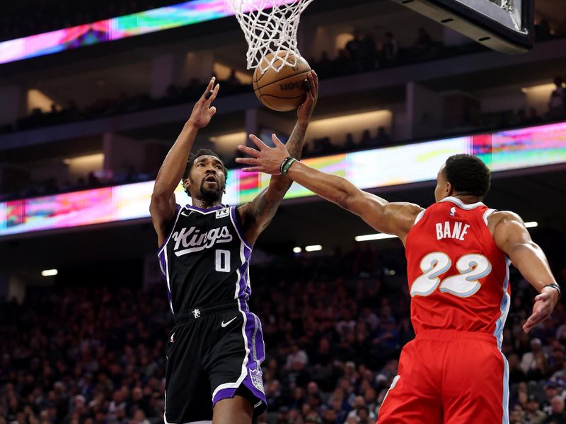 SACRAMENTO, CALIFORNIA - JANUARY 03: Malik Monk #0 of the Sacramento Kings goes up for a shot on Desmond Bane #22 of the Memphis Grizzlies in the first half at Golden 1 Center on January 03, 2025 in Sacramento, California. NOTE TO USER: User expressly acknowledges and agrees that, by downloading and/or using this photograph, user is consenting to the terms and conditions of the Getty Images License Agreement.   (Photo by Ezra Shaw/Getty Images)