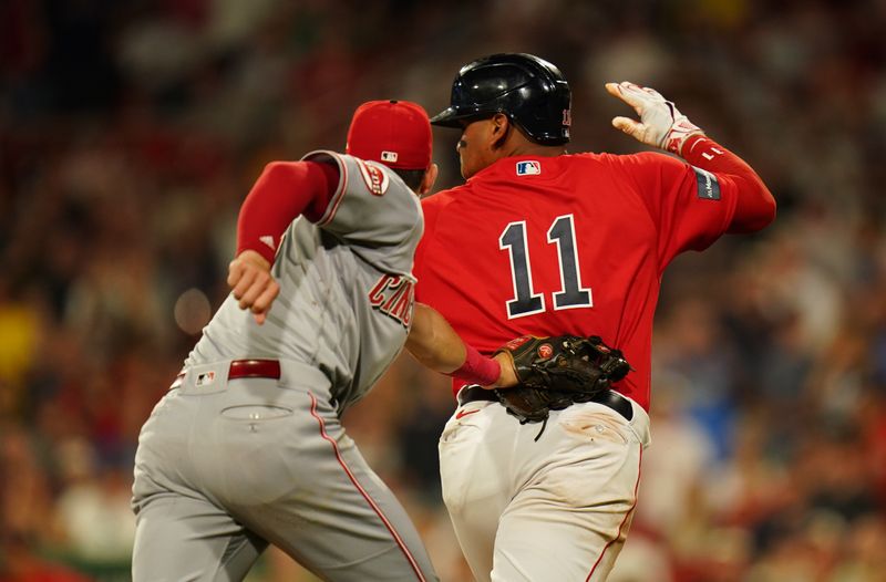 Jun 1, 2023; Boston, Massachusetts, USA; Boston Red Sox third baseman Rafael Devers (11) tagged out by Cincinnati Reds shortstop Kevin Newman (28) in the eighth inning at Fenway Park. Mandatory Credit: David Butler II-USA TODAY Sports