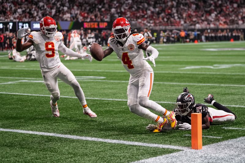 Kansas City Chiefs wide receiver Rashee Rice (4) scores a touchdown against Atlanta Falcons cornerback Dee Alford (20) during the first half of an NFL football game, Sunday, Sept. 22, 2024, in Atlanta. (AP Photo/John Bazemore)