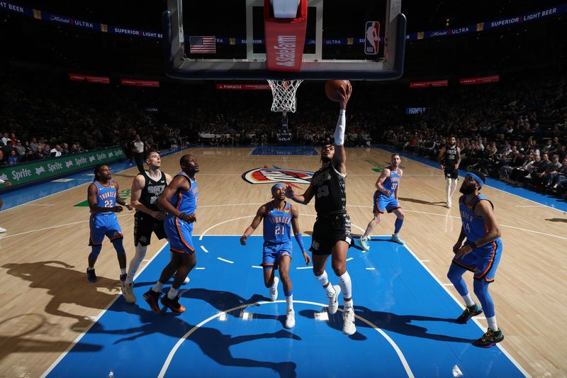 OKLAHOMA CITY, OK - APRIL 10:  Tre Jones #33 of the San Antonio Spurs drives to the basket during the game against the Oklahoma City Thunder on April 10, 2024 at Paycom Arena in Oklahoma City, Oklahoma. NOTE TO USER: User expressly acknowledges and agrees that, by downloading and or using this photograph, User is consenting to the terms and conditions of the Getty Images License Agreement. Mandatory Copyright Notice: Copyright 2024 NBAE (Photo by Zach Beeker/NBAE via Getty Images)