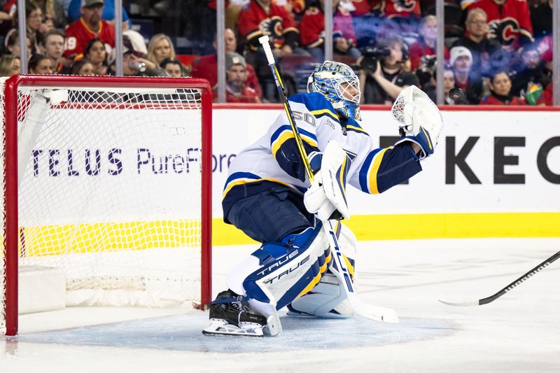Dec 5, 2024; Calgary, Alberta, CAN; St. Louis Blues goaltender Jordan Binnington (50) catches the puck during the second period against the Calgary Flames at Scotiabank Saddledome. Mandatory Credit: Brett Holmes-Imagn Images