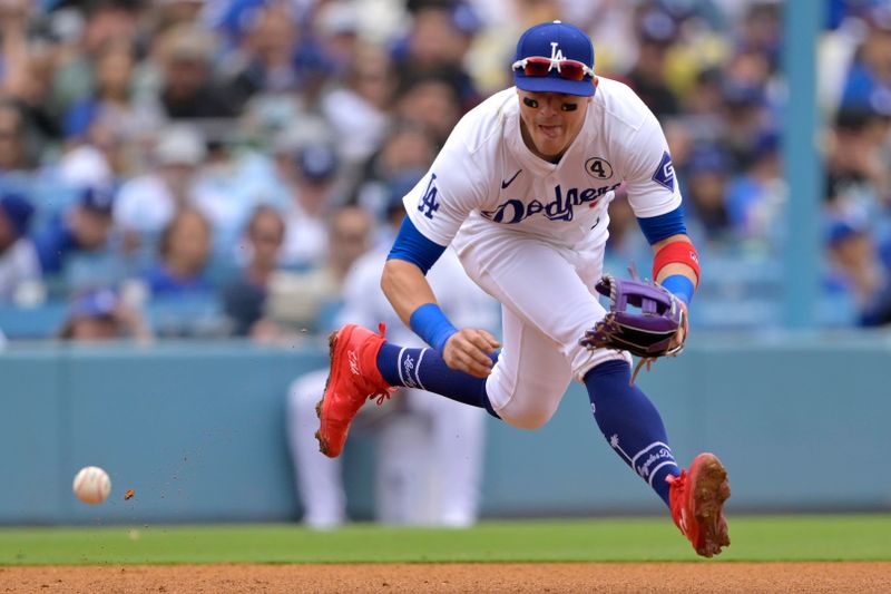 Jun 2, 2024; Los Angeles, California, USA;  Los Angeles Dodgers third baseman Enrique Hernandez (8) makes a play and throws out Colorado Rockies third baseman Ryan McMahon (24) at first in the sixth inning at Dodger Stadium. Mandatory Credit: Jayne Kamin-Oncea-USA TODAY Sports