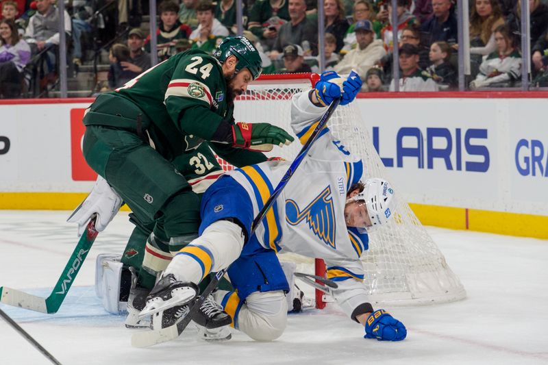 Mar 1, 2026; Saint Paul, Minnesota, USA; Minnesota Wild defenseman Zach Bogosian (24) upends St. Louis Blues left wing Jake Neighbours (63) in front of the net in the third period at Grand Casino Arena. Mandatory Credit: Matt Blewett-Imagn Images