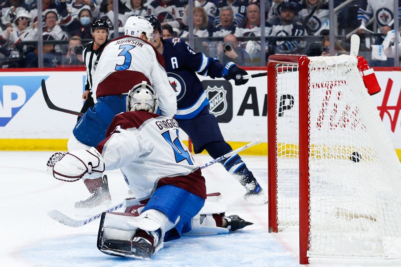 Apr 23, 2024; Winnipeg, Manitoba, CAN; Winnipeg Jets forward Mark Scheifele (55) scores on Colorado Avalanche goalie Alexander Georgiev (40) during the second period in game two of the first round of the 2024 Stanley Cup Playoffs at Canada Life Centre. Mandatory Credit: Terrence Lee-USA TODAY Sports