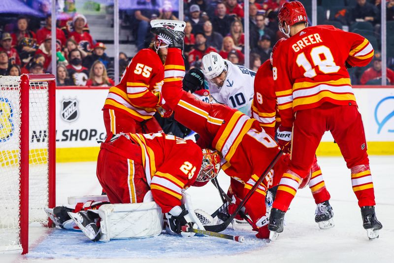 Dec 27, 2023; Calgary, Alberta, CAN; Calgary Flames goaltender Jacob Markstrom (25) makes a save against Seattle Kraken center Matty Beniers (10) during the third period at Scotiabank Saddledome. Mandatory Credit: Sergei Belski-USA TODAY Sports