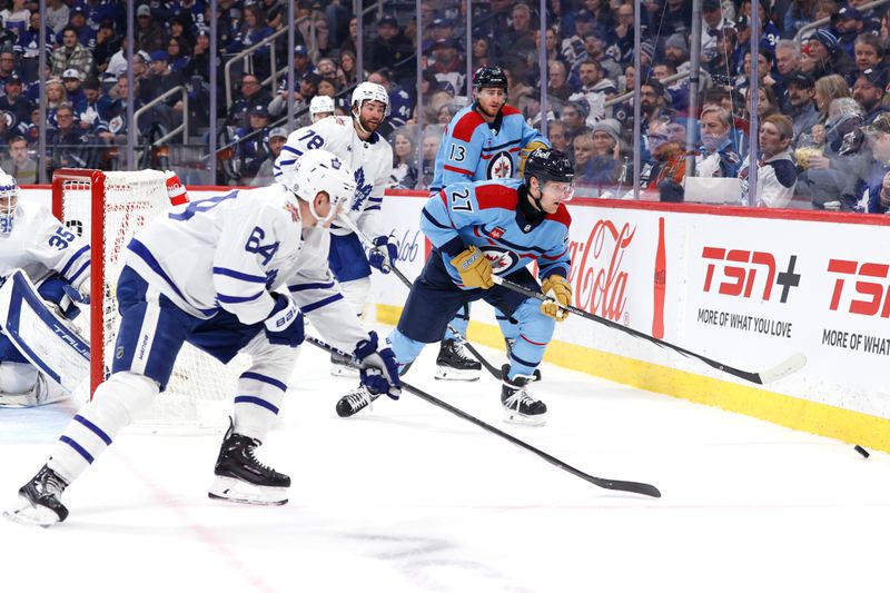 Jan 27, 2024; Winnipeg, Manitoba, CAN; Toronto Maple Leafs center David Kampf (64) and Winnipeg Jets left wing Nikolaj Ehlers (27) chase down the puck in the second period at Canada Life Centre. Mandatory Credit: James Carey Lauder-USA TODAY Sports