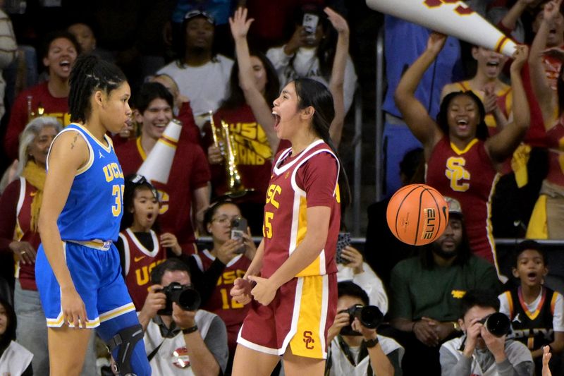 Jan 14, 2024; Los Angeles, California, USA; USC Trojans guard Kayla Padilla (45) celebrates as UCLA Bruins guard Camryn Brown (35) walks off the court at the end of the game at Galen Center. Mandatory Credit: Jayne Kamin-Oncea-USA TODAY Sports