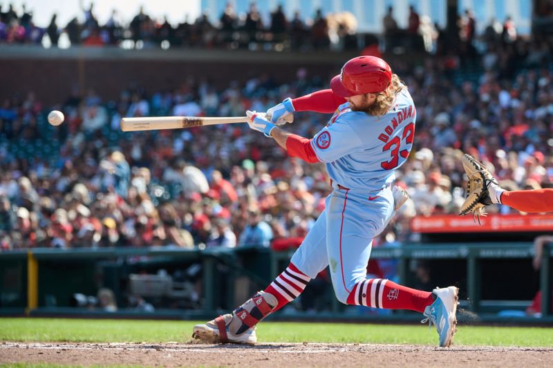 Sep 28, 2024; San Francisco, California, USA; St. Louis Cardinals outfielder Brendan Donovan (33) hits a single against the San Francisco Giants during the fifth inning at Oracle Park. Mandatory Credit: Robert Edwards-Imagn Images