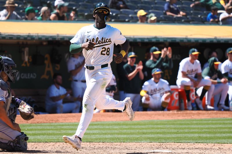 May 23, 2024; Oakland, California, USA; Oakland Athletics left fielder Daz Cameron (28) scores a run against the Colorado Rockies during the eleventh inning at Oakland-Alameda County Coliseum. Mandatory Credit: Kelley L Cox-USA TODAY Sports