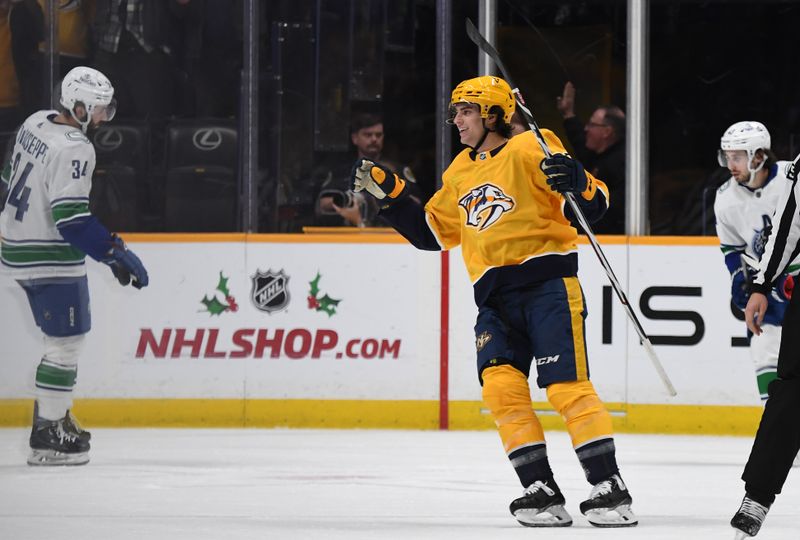 Dec 19, 2023; Nashville, Tennessee, USA; Nashville Predators right wing Luke Evangelista (77) celebrates after assisting on a goal by defenseman Jeremy Lauzon (not pictured) during the second period against the Vancouver Canucks at Bridgestone Arena. Mandatory Credit: Christopher Hanewinckel-USA TODAY Sports