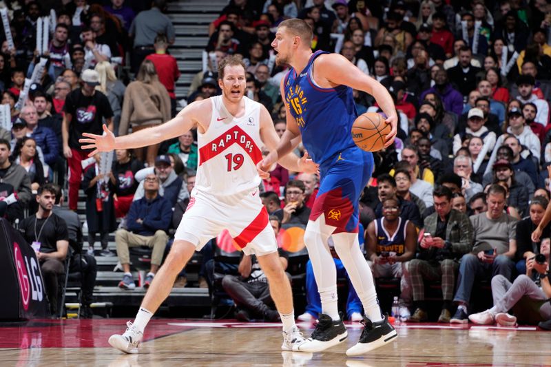 TORONTO, CANADA - OCTOBER 28: Jakob Poeltl #19 of the Toronto Raptors defends against the Denver Nuggets on October 28, 2024 at the Scotiabank Arena in Toronto, Ontario, Canada.  NOTE TO USER: User expressly acknowledges and agrees that, by downloading and or using this Photograph, user is consenting to the terms and conditions of the Getty Images License Agreement.  Mandatory Copyright Notice: Copyright 2024 NBAE (Photo by Mark Blinch/NBAE via Getty Images)