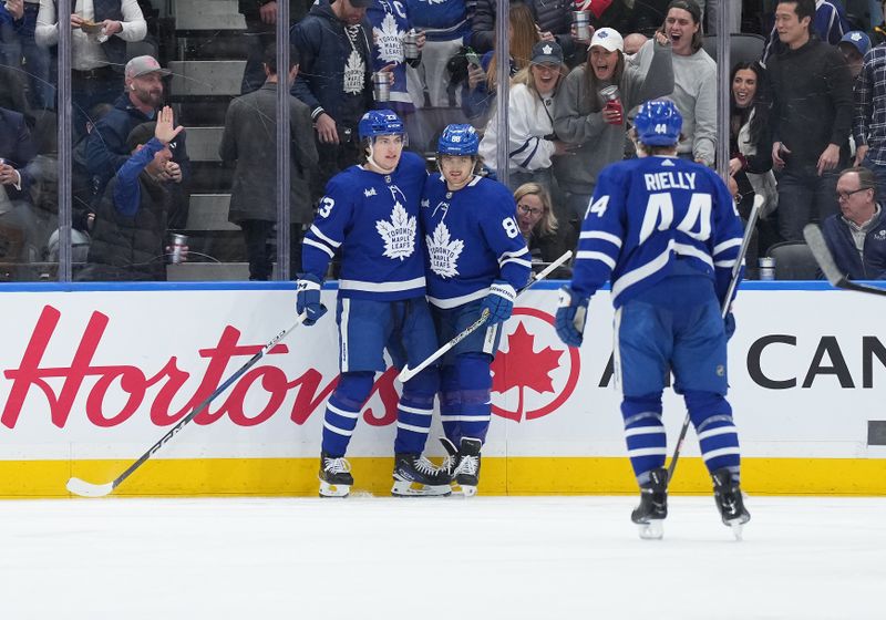 Apr 8, 2024; Toronto, Ontario, CAN; Toronto Maple Leafs left wing Matthew Knies (23) scores a goal and celebrates with right wing William Nylander (88) against the Pittsburgh Penguins during the second period at Scotiabank Arena. Mandatory Credit: Nick Turchiaro-USA TODAY Sports