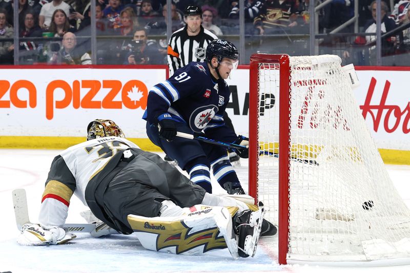 Mar 24, 2026; Winnipeg, Manitoba, CAN; Winnipeg Jets center Cole Perfetti (91) scores on Vegas Golden Knights goaltender Adin Hill (33) in the second period at Canada Life Centre. Mandatory Credit: James Carey Lauder-Imagn Images