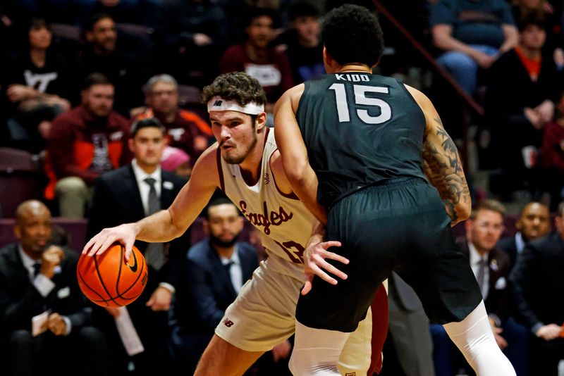 Jan 23, 2024; Blacksburg, Virginia, USA; Boston College Eagles forward Quinten Post (12) drives to the basket against Virginia Tech Hokies center Lynn Kidd (15) during the first half at Cassell Coliseum. Mandatory Credit: Peter Casey-USA TODAY Sports