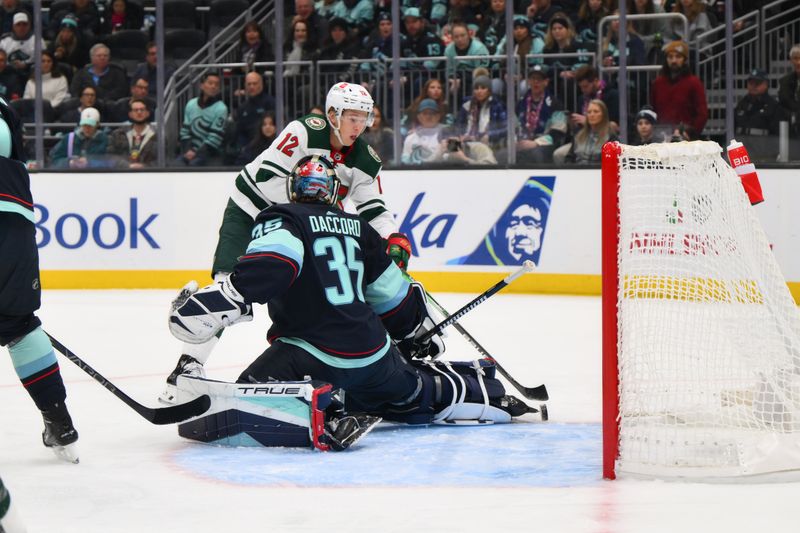 Dec 10, 2023; Seattle, Washington, USA; Minnesota Wild left wing Matt Boldy (12) scores a goal past Seattle Kraken goaltender Joey Daccord (35) during the first period at Climate Pledge Arena. Mandatory Credit: Steven Bisig-USA TODAY Sports