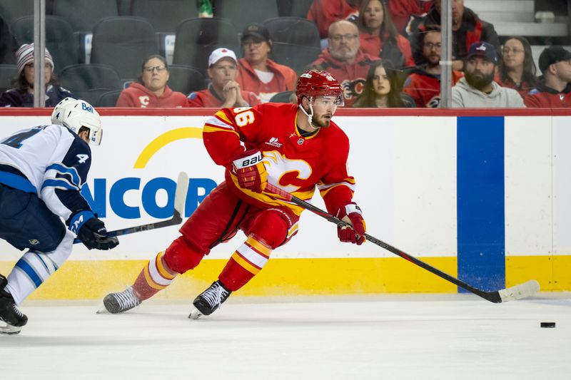 Oct 20, 2025; Calgary, Alberta, CAN; Calgary Flames left wing Joel Farabee (86) skates with the puck against the Winnipeg Jets during the second period at Scotiabank Saddledome. Mandatory Credit: Brett Holmes-Imagn Images