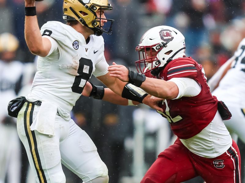 Nov 11, 2023; Columbia, South Carolina, USA; Vanderbilt Commodores quarterback Ken Seals (8) throws as he is hit by South Carolina Gamecocks linebacker Stone Blanton (52) in the second half at Williams-Brice Stadium. Mandatory Credit: Jeff Blake-USA TODAY Sports