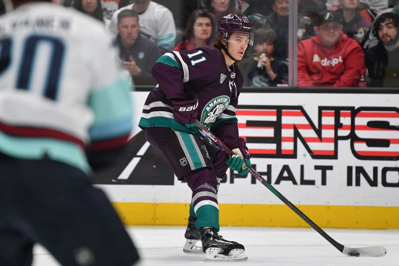 Dec 23, 2023; Anaheim, California, USA; Anaheim Ducks center Trevor Zegras (11) moves the puck against the Seattle Kraken during the second period at Honda Center. Mandatory Credit: Gary A. Vasquez-USA TODAY Sports