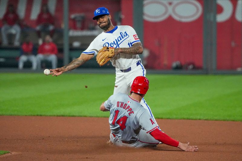 Aug 19, 2024; Kansas City, Missouri, USA; Kansas City Royals third base Maikel Garcia (11) gets a force out on Los Angeles Angels catcher Logan O'Hoppe (14) at second base and throws to first for a double play in the ninth inning at Kauffman Stadium. Mandatory Credit: Denny Medley-USA TODAY Sports